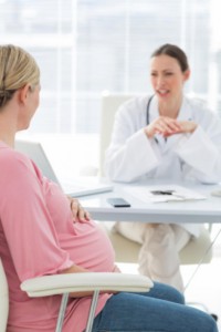 pregnant woman discussing with doctor